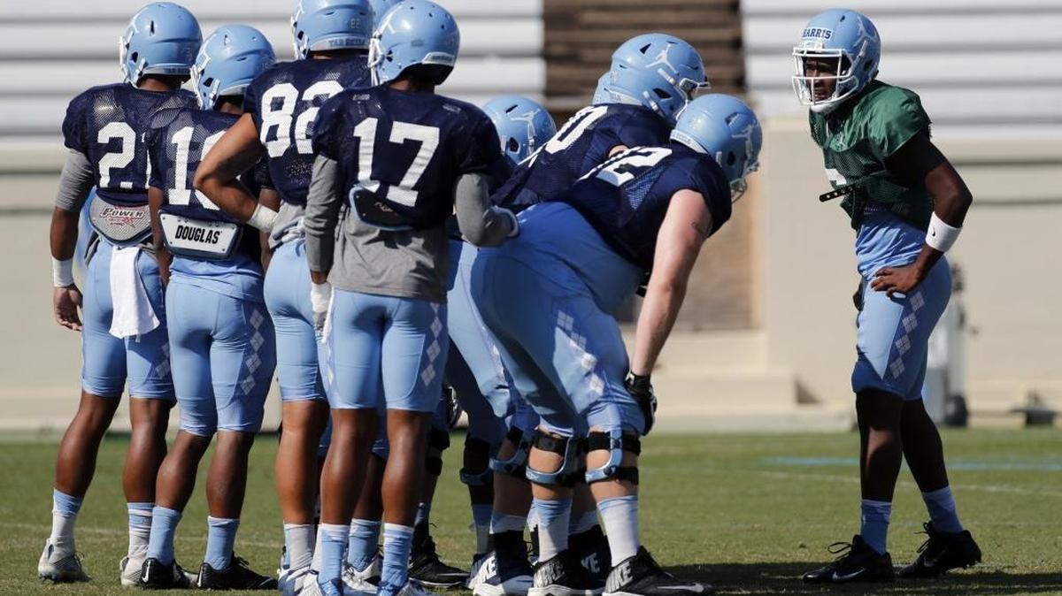 UNC quarterback Brandon Harris, right, calls a play with his teammates at practice on Aug. 10.