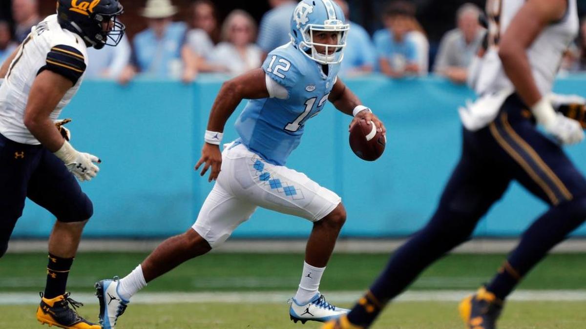 UNC quarterback Chazz Surratt, middle, rolls out against California on Saturday.