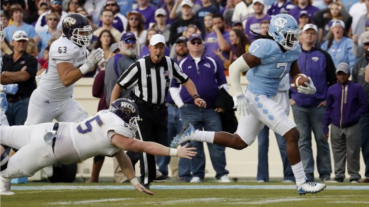 UNC’s Jonathan Smith (7) evades WCU’s Kaleb Spry (65) after he scoops up a fumble and runs it back for a TD during the second quarter of an NCAA college football game played between the UNC Tar Heels and the Western Carolina Catamounts at Kenan Stadium in Chapel Hill, NC, on Nov. 18, 2017.
