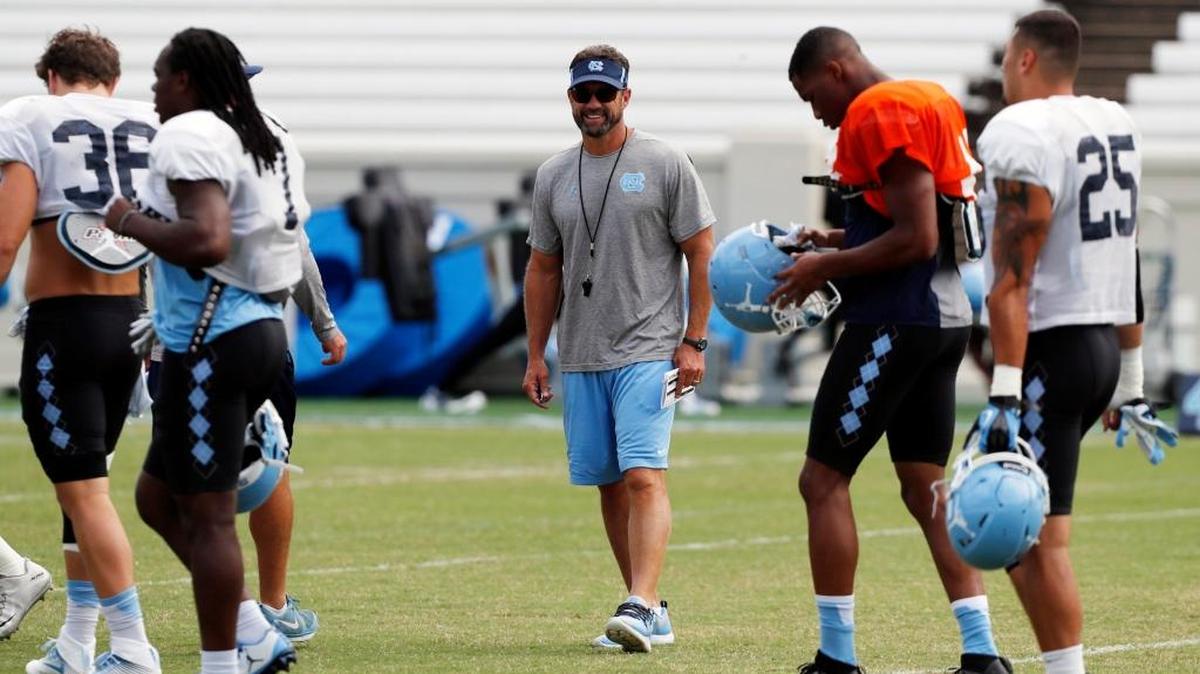 UNC coach Larry Fedora enjoys a laugh with some of the players at practice on Aug. 24. The Tar Heels open the season Saturday against Cal.