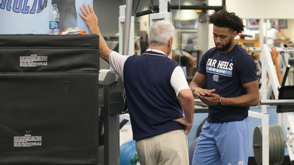North Carolina’s Joel Berry II, right, shows coach Roy Williams his right hand as Berry and his teammates work out in the weight room prior to practice on Monday.