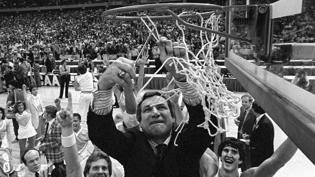 North Carolina basketball coach Dean Smith cuts the net as players and fans cheer after the Tar Heels defeated Georgetown for the NCAA championship in 1982.