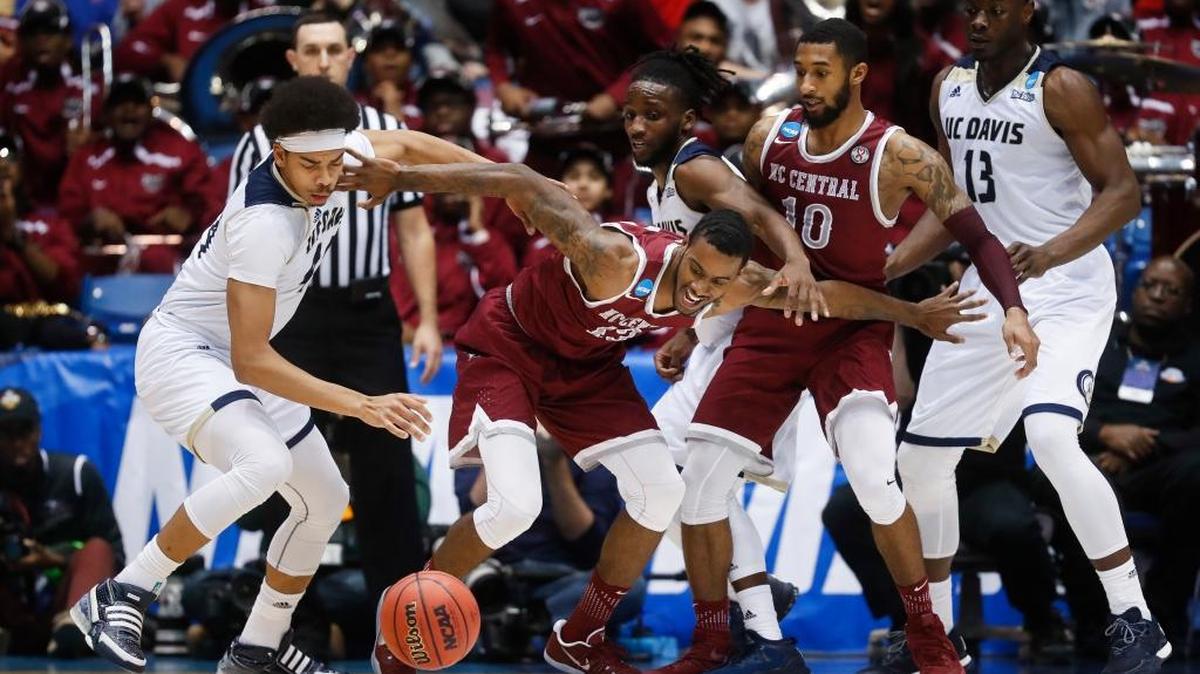N.C. Central’s Pablo Rivas, center, and UC Davis’ Garrison Goode, left, scramble for a wild ball during the NCAA tournament in March.
