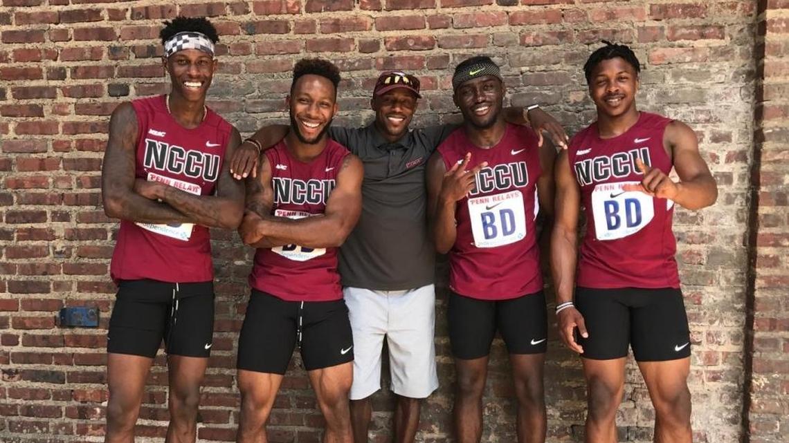 Deontae Williams, Jonathan Williams, coach Tavius "T.J." Walker, Blake Hartsfield, Isaac Roberts of North Carolina Central, celebrate after the 4x100 relay at the Penn Relays Saturday afternoon.
