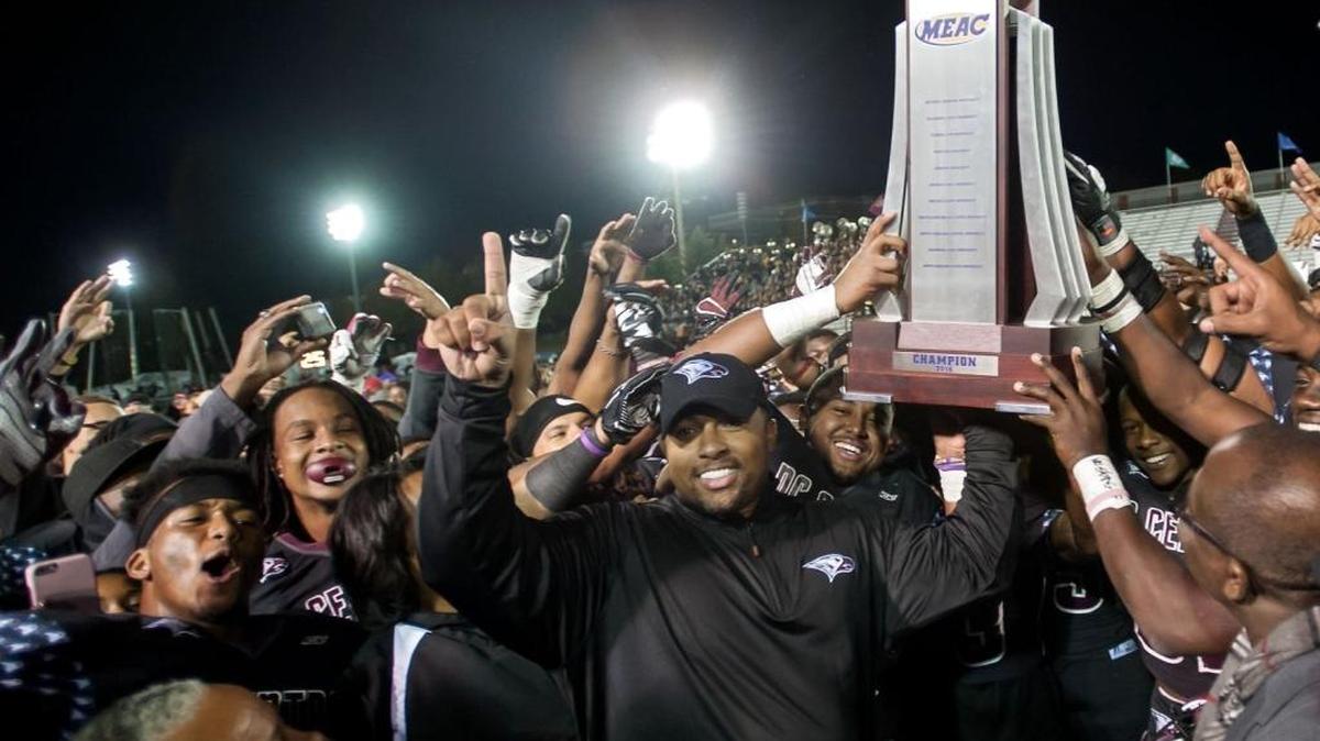 NCCU football coach Jerry Mack (center) celebrates the team’s MEAC football championship last November