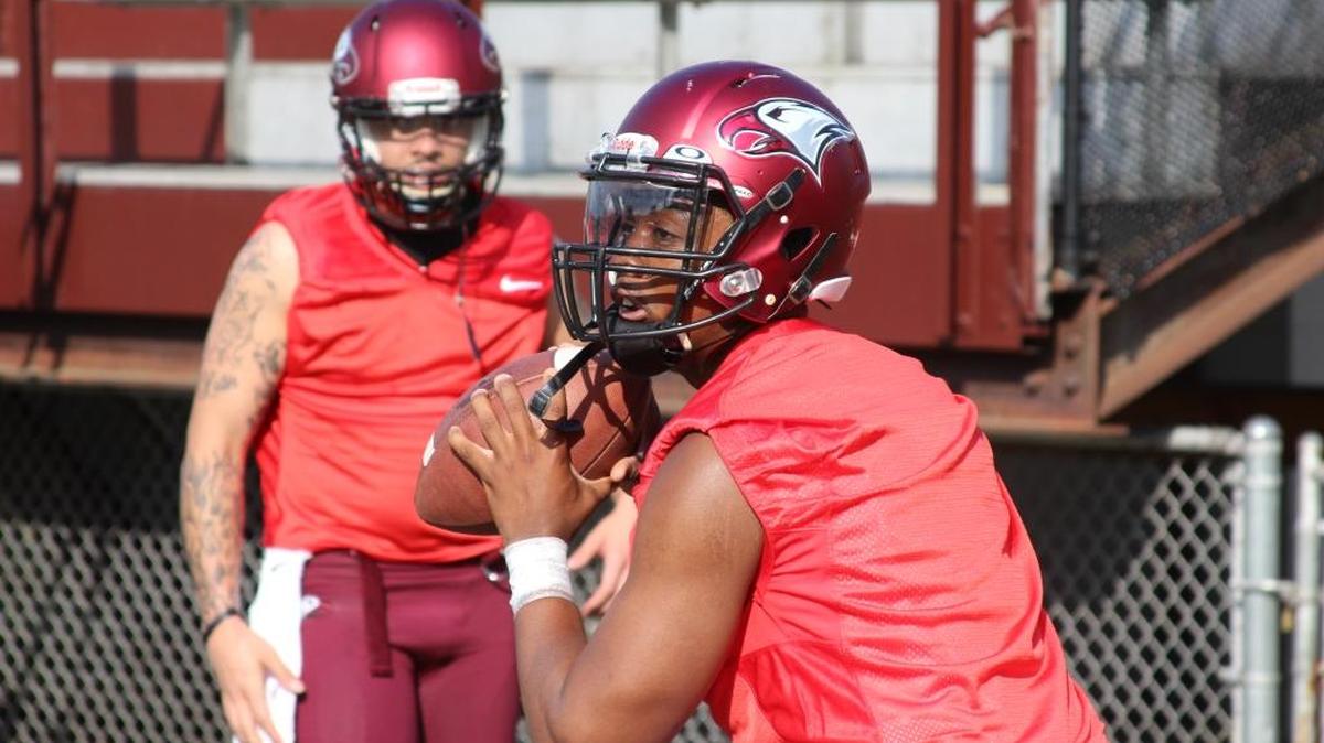 North Carolina Central quarterback Naiil Ramadan makes a throw during practice as Shaolin McGuire watches.