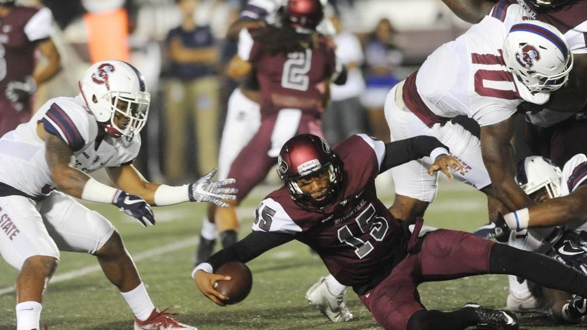 NC Central's quarterback Micah Zanders battles S.C. State for yardage on Thursday night.