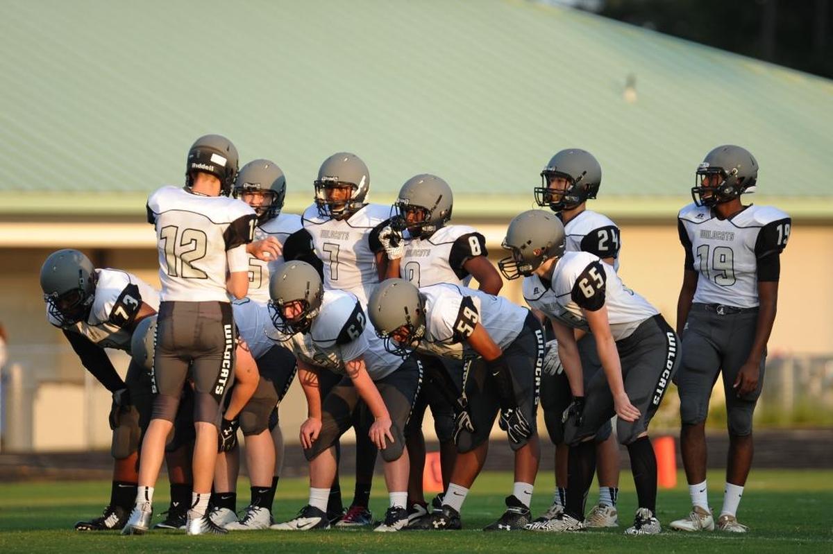 East Chapel Hill huddles at the beginning of the JV football game between the East Chapel Hill Wildcats and the Carrboro Jaguars, which was played in Carrboro on Thursday, August 24, 2017.