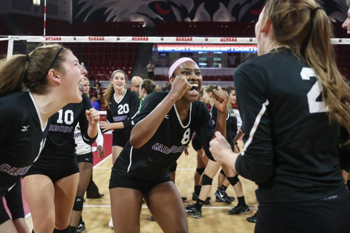 Carrboro's Destiny Cox celebrates the team's championship with her teammates. The Carrboro Jaguars played against the West Iredell Warriors in the high school NCHSAA 2A State Championship volleyball game on Nov. 4, 2017.
