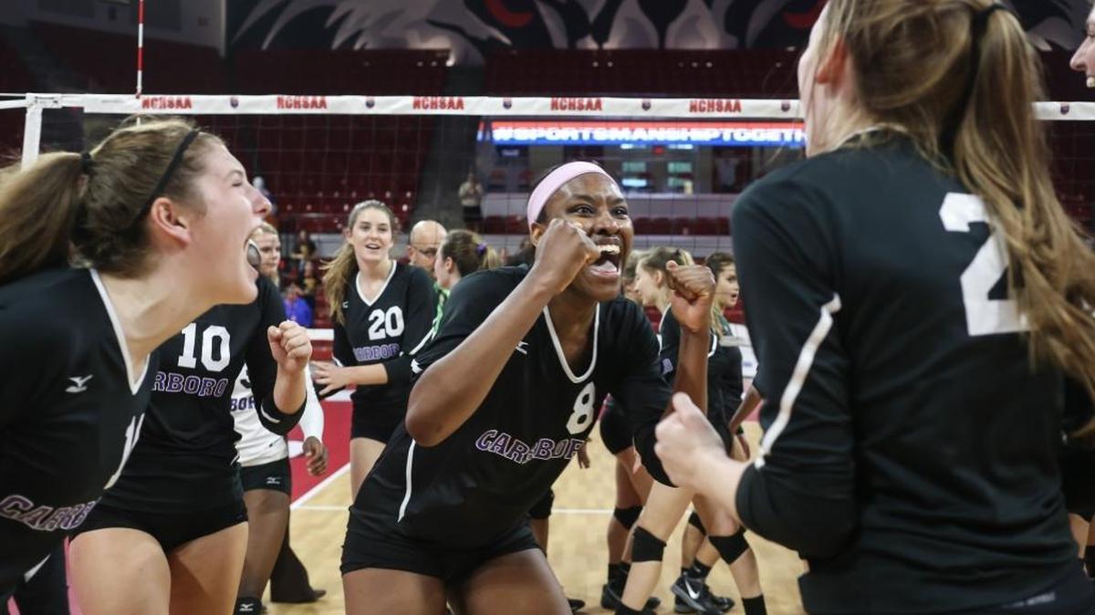 Carrboro's Destiny Cox celebrates the team's championship with her teammates. The Carrboro Jaguars played against the West Iredell Warriors in the high school NCHSAA 2A State Championship volleyball game on Nov. 4, 2017.