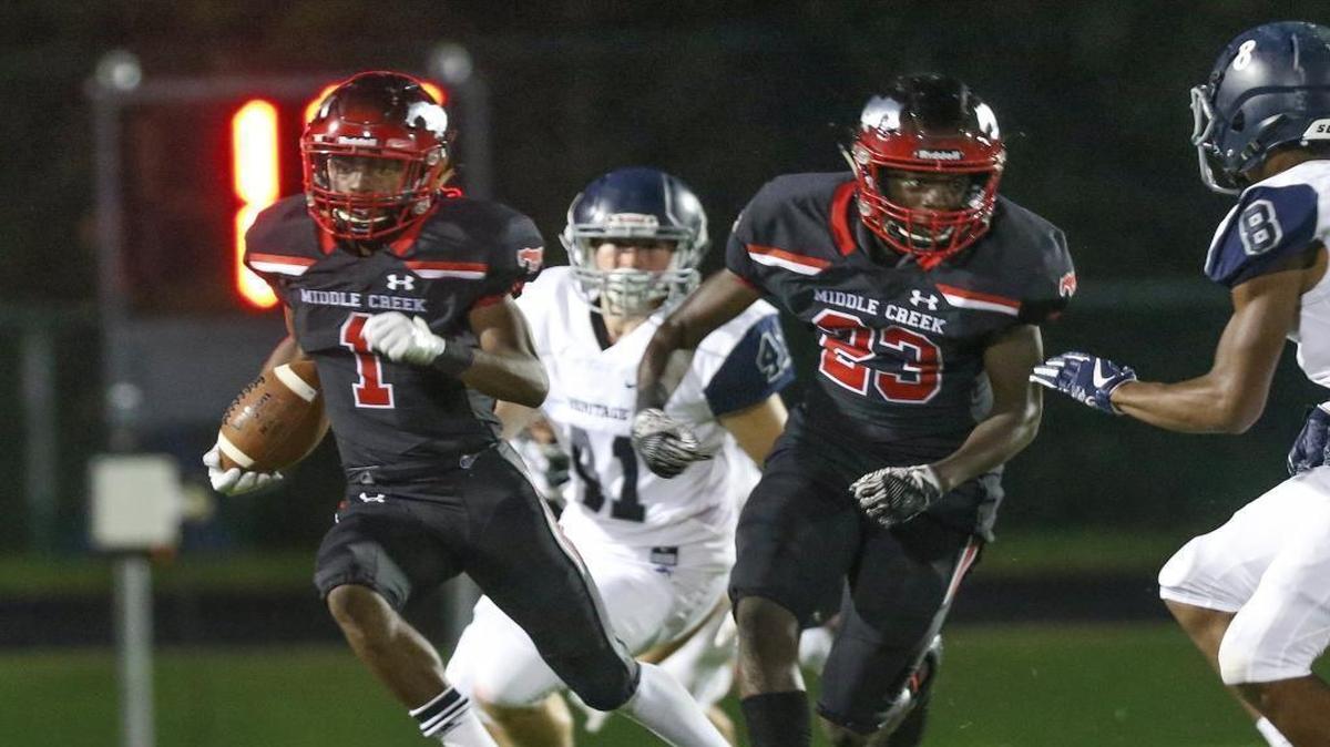 Middle Creek's Rasheed Martin, Jr. (1) follows the blocking of teammate Brandon Wilson (23) on a 3rd quarter kickoff return. Coverage from Heritage Huskies and the Middle Creek Mustangs played in Apex, N.C. on Friday, August 25, 2017. Heritage defeated Middle Creek 47-27.