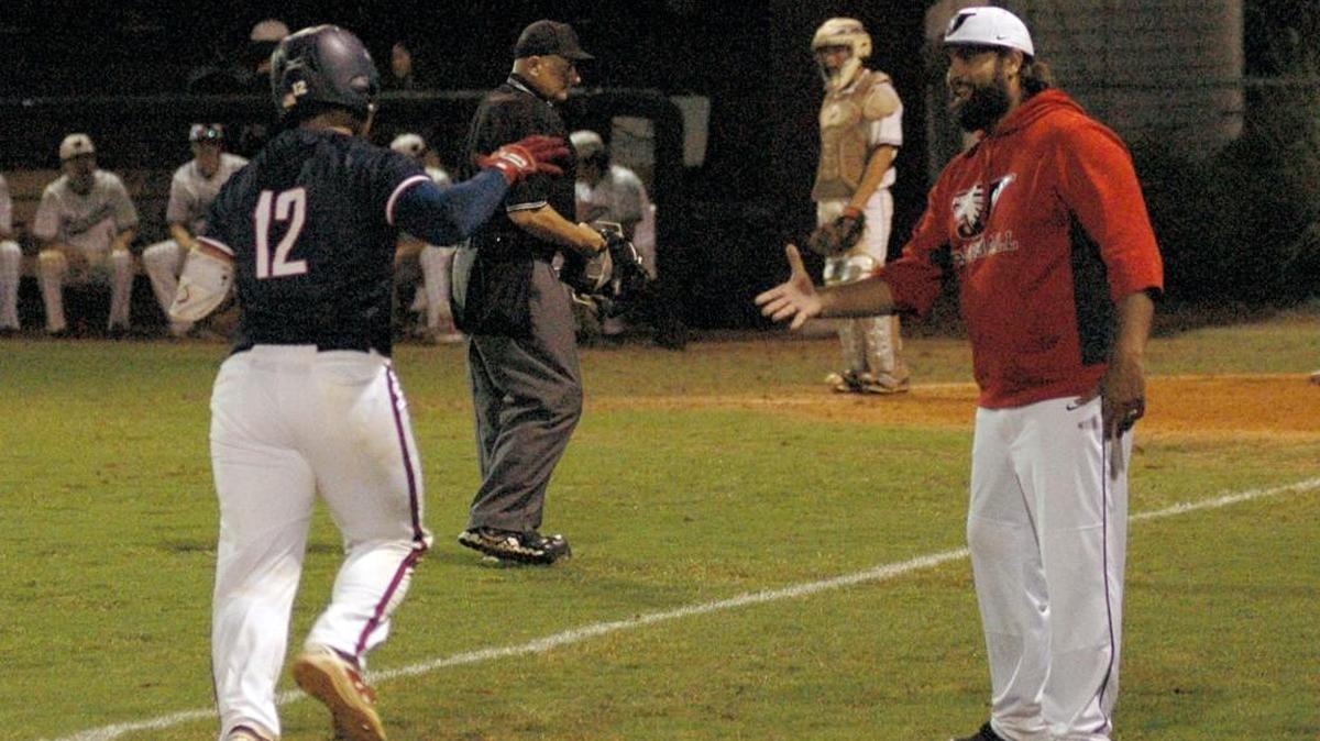 Jordan coach Aaron Brown reaches out to congratulate Chris Shepherd (12) as he rounds third to score on a solo home run in the Falcons' 13-2 win at Wakefield on Monday, May 1, 2017.