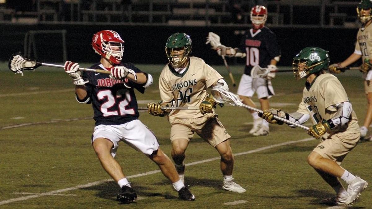 Jordan's Jack Perry (22) prepares to shoot as Jake Strother (26) and Jack Biestek of Cardinal Gibbons play defense on Tuesday, May 9, 2017 in the third round of the 4-A state lacrosse playoffs. Cardinal Gibbons won 18-5.