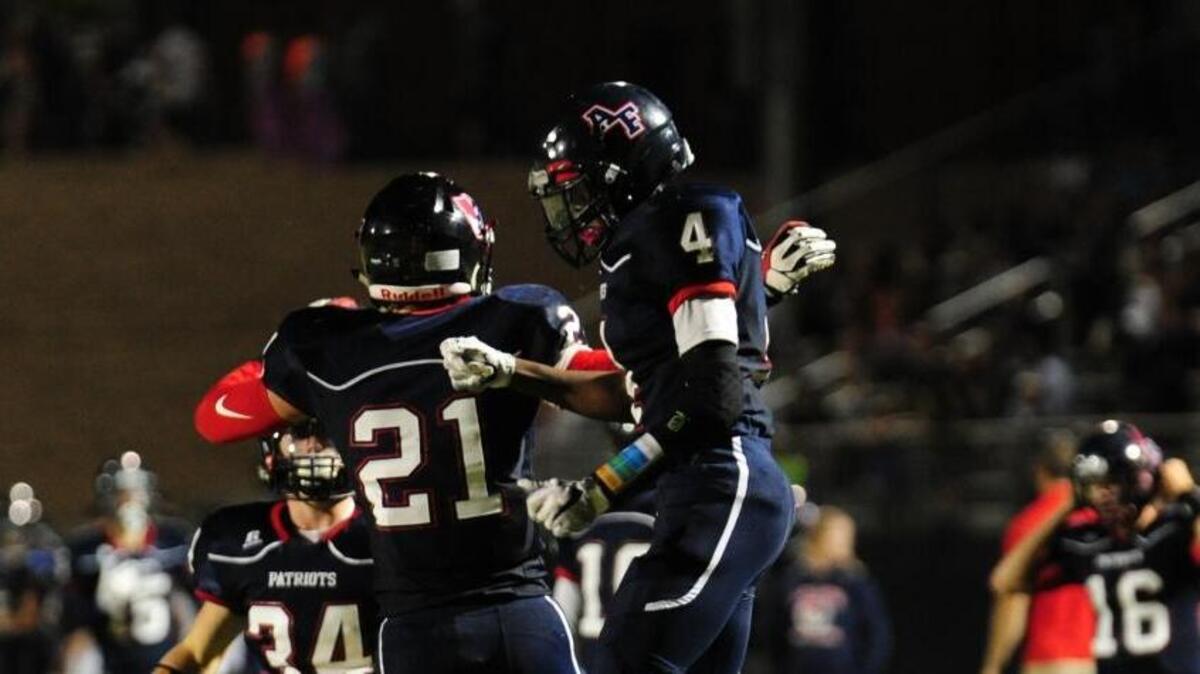 Apex Friendship's Jacob Kelley (21) and Scott Sidney (4) celebrate a touchdown against Panther Creek during the football game, which was played on Friday, September 8, 2017 in Apex.