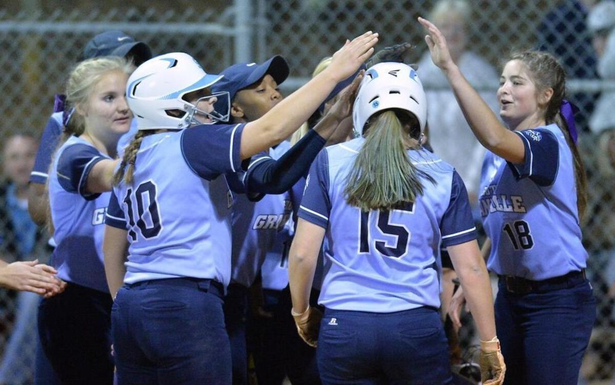 South Granville's Miranda Barker (15) is congratulated by teammates after hitting a solo home run against Oxford Webb earlier this season. South Granville will try to win its third straight 2A state championship beginning on Friday agiainst Monroe Parkwood.
