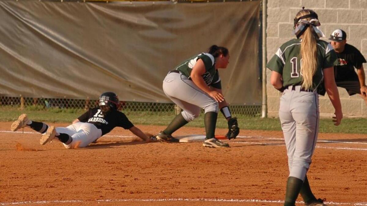 Oxford Webb's Meri Bostic dives back into first base against West Brunswick in the third round of the N.C. High School Athletic Association softball playoffs on Tuesday, May 16, 2016. Webb lost 3-2.
