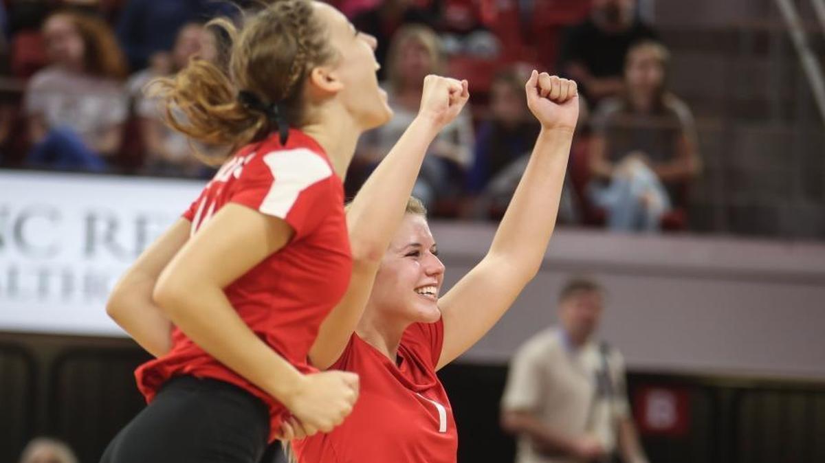Roxboro's Jordan Taylor (14) and MacKenzi Thornburg (1) celebrate a point. The Community School of Davidson Spartans played against the Roxboro Community Bulldogs in the high school NCHSAA 1A State Championship volleyball game on Nov. 4, 2017.