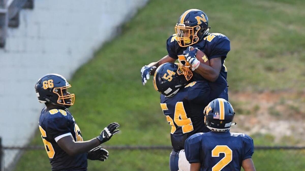 Daylan Felton (22) of Northern celebrates a touchdown along his teammates Tyric Swennie (66), Trevor Hausmann (54) and Jer'ald Brown (2). The Northern Knights played the Person Rockets in a football game that took place in Durham, N.C. on Friday, August 26 2017.