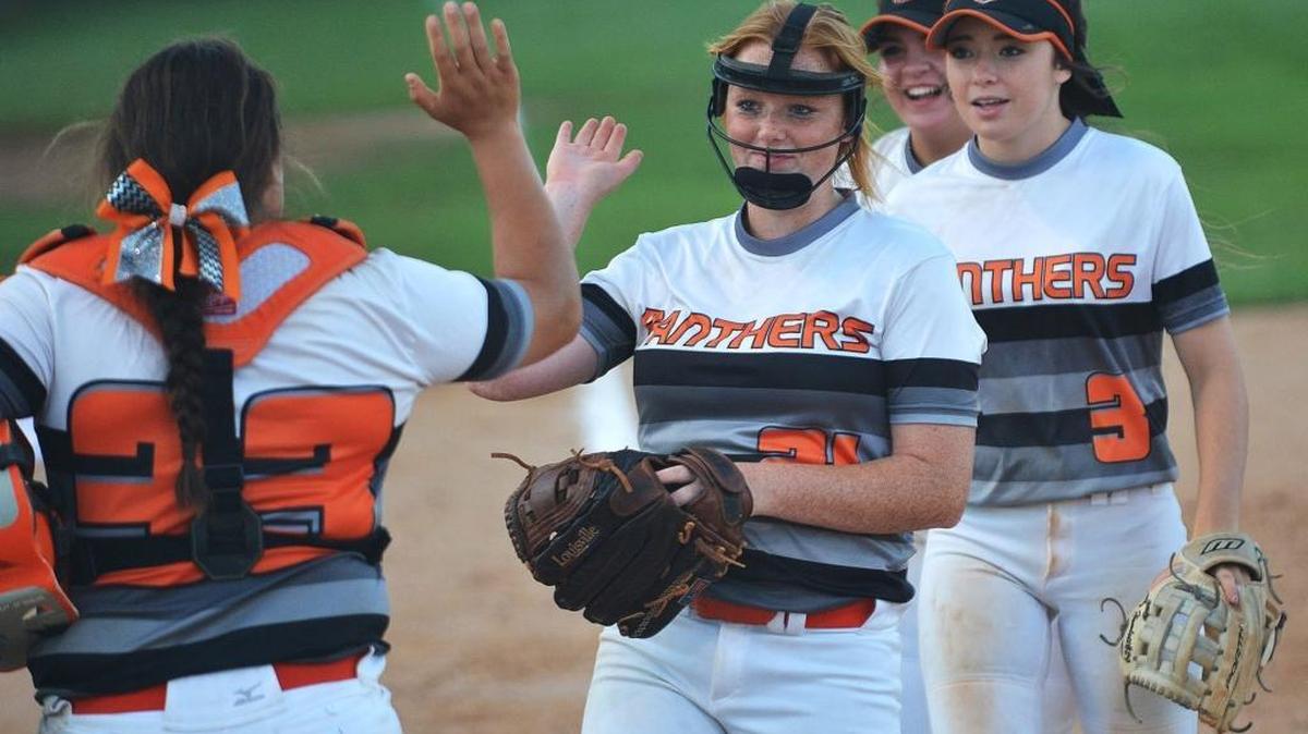 Orange's Mia Davidson (33), Kristina Givens, and Abigail Hamlett (3) celebrate after defeating West Brunswick at Orange High School. Orange will play on Friday night in the 3A state championship series.
