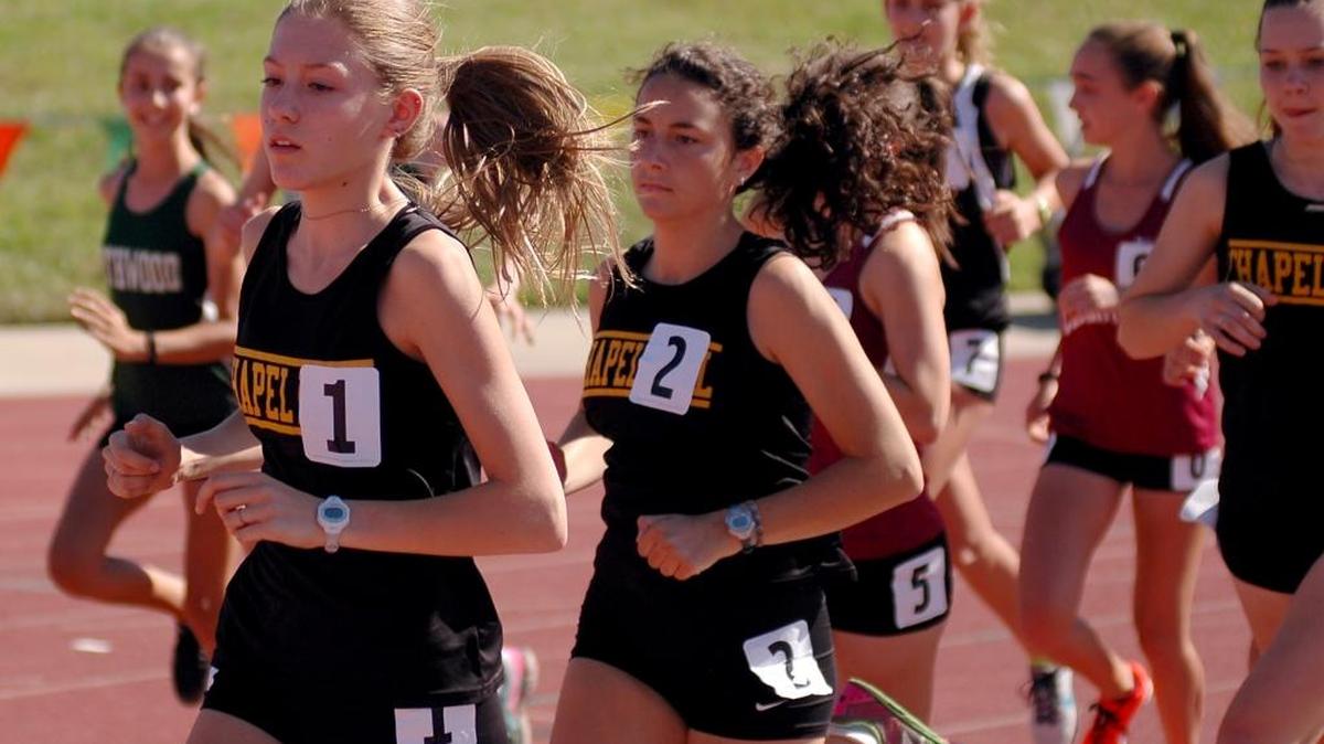 Chapel Hill's Katherine Dokholyan (1) and Maeve Gualtieri-Reed (2) lead the pack at the start of the 1,600 at the Big Eight track championships on Wednesday, May 3, 2017 at Durham County Stadium.
