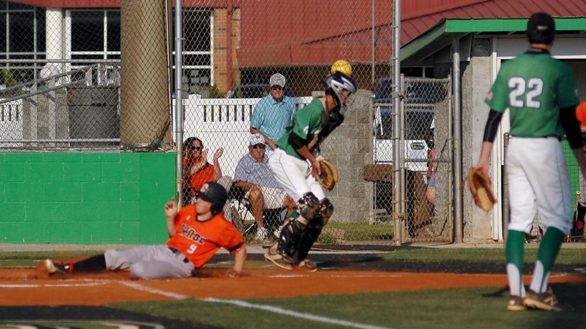 Orange's Joey Berini slides into home in the top of the first inning against West Brunswick in the third round of the N.C. High School Athletic Association baseball playoffs on Tuesday, May 16, 2017. Orange lost 2-1 in nine innings.