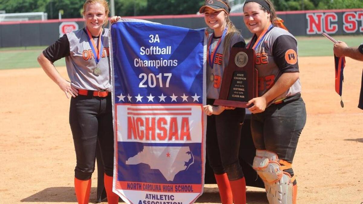 Orange's captains with the State Championship banner during the N.C. 3A State Championship softball game with the Piedmont Panthers high school and the Orange Panther high school in Raleigh N.C. on June 3, 2017. Orange won the game 4-1.