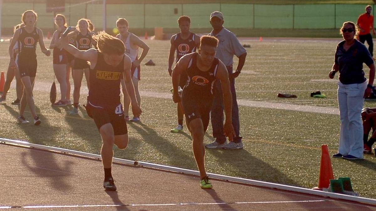 Orange's Jamar Davis (right) battles with Chapel Hill's Dylan Blankenship (left) to the line in the 1,600 relay at the Big Eight track championships on Wednesday, May 3, 2017 at Durham County Stadium. Davis finished .02 seconds ahead for the win.