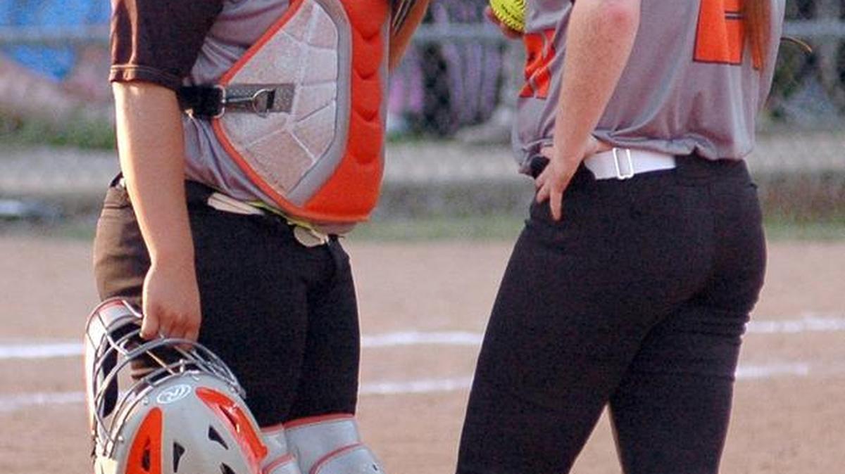 Orange catcher Mia Davidson (left) talks with starting pitcher Kristina Givens (right) during an April 28, 2017, game.