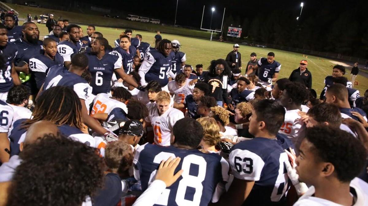 Players from Orange and Hillside shared a prayer and words of encouragement together after Orange running back Marvante Beasley was injured on the first play from scrimmage in the third quarter on Oct. 13, 2017. Beasley was moving his arms and legs as he was taken to an ambulance for further evaluation.