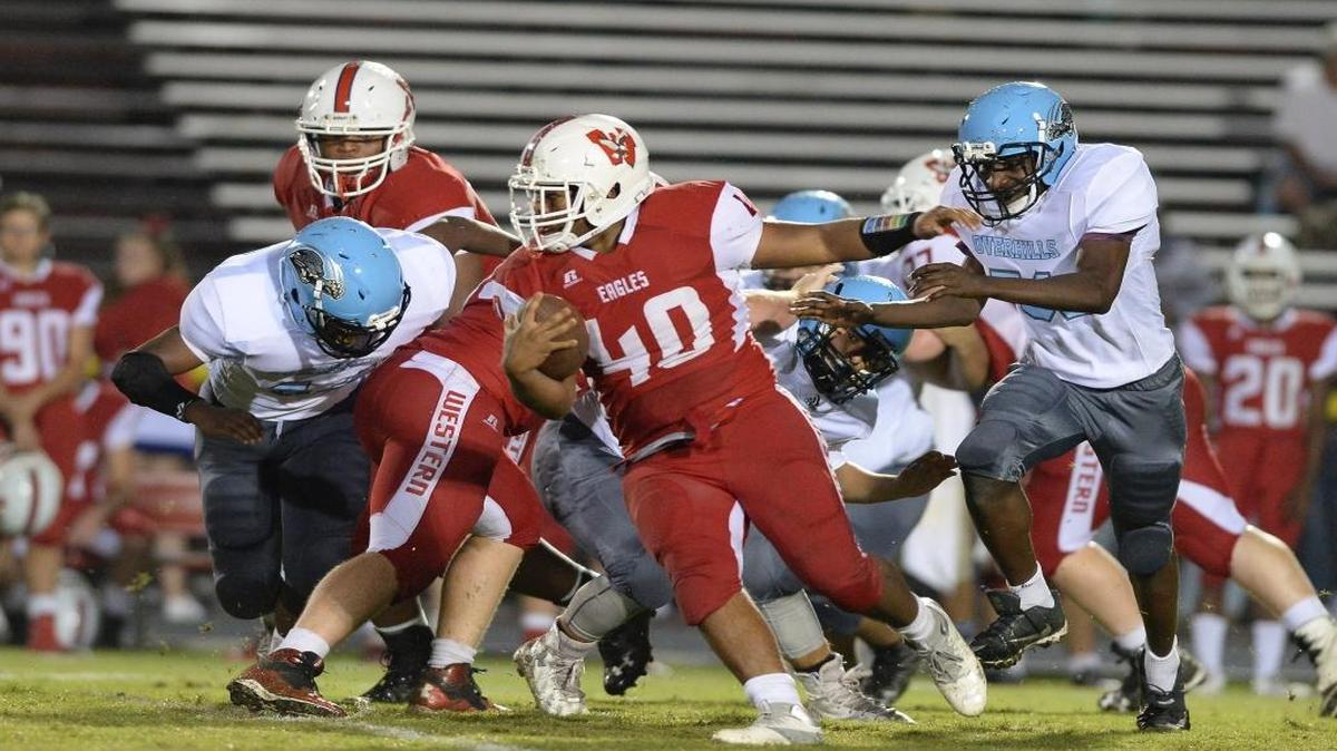 Gordon Thomas (40) of Western Harnett carries the ball against the pursuit of D'shaun Mcfarlane, right, of Overhills. The Western Harnett Eagles played the Overhills Jaguars in a football game that took place in Lillington, N.C. on Thursday, August 31 2017. Overhills won 48-28.