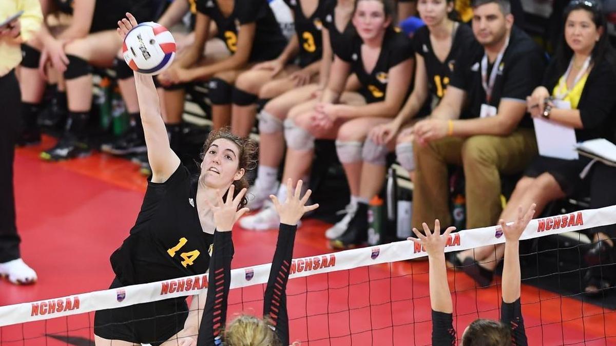 Kaya Merkler (14) of Chapel Hill spikes the ball over the defense from Meredith Patterson, center, and Savannah Stewart (20) of North Iredell. The Chapel Hill Tigers played the North Iredell Raiders in the 3A NCHSAA volleyball final that took place at the N.C. State's Reynolds Coliseum in Raleigh, N.C. on Saturday, November 4, 2017. North Iredell won 3-2.