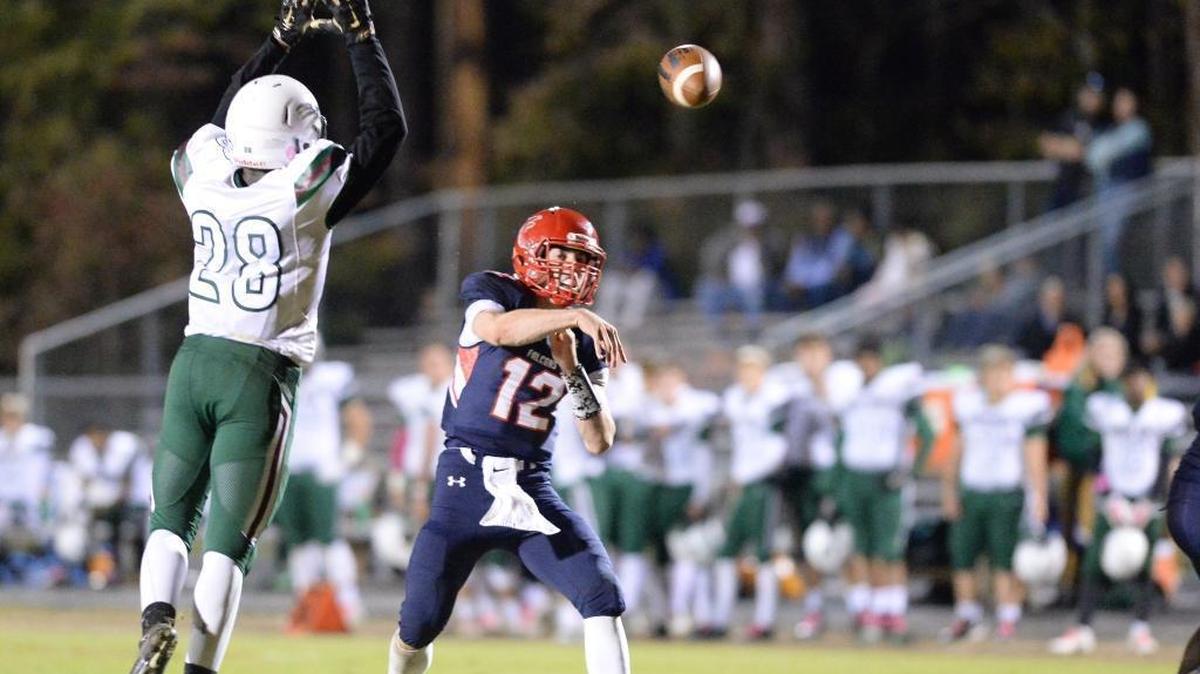 Jordan quarterback Ben Miller threads the needle in an Oct. 27 high school football game against the Green Hope Falcons.