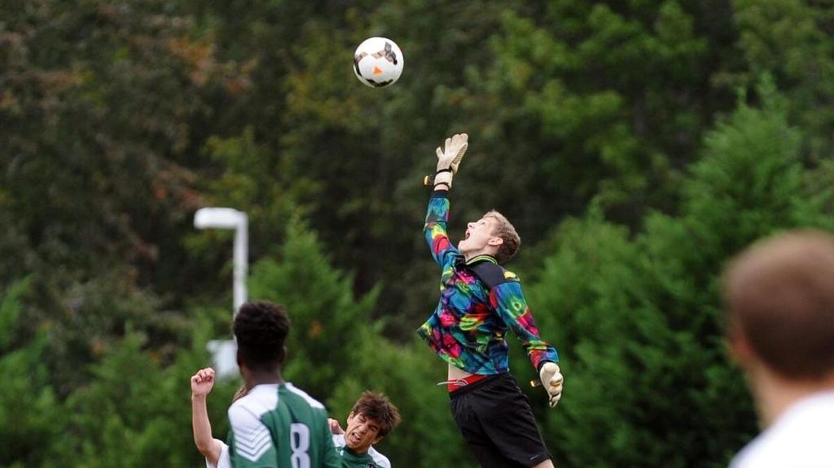 Research Triangle goalkeeper Chandler Frye makes a save during the boys soccer game against Raleigh Charter, which was played in Cary on Wednesday, October 5, 2016. Raleigh Charter won 5-1.