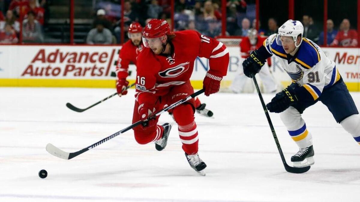 The Canes' Elias Lindholm (16) moves the puck against the St. Louis Blues' Vladimir Tarasenko (91) at PNC Arena on April 8, 2017.