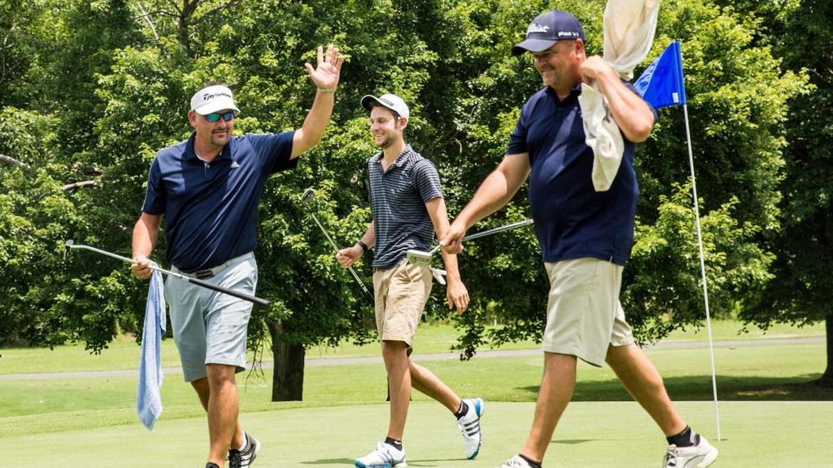 Ronnie WIlliams, left, Micah Holloway, and Mike Smith, celebrate the end of the 3rd hole during the Herald-Sun 2nd round of qualifying at Hillandale Golf Course on June 20, 2017, in Durham, N.C.