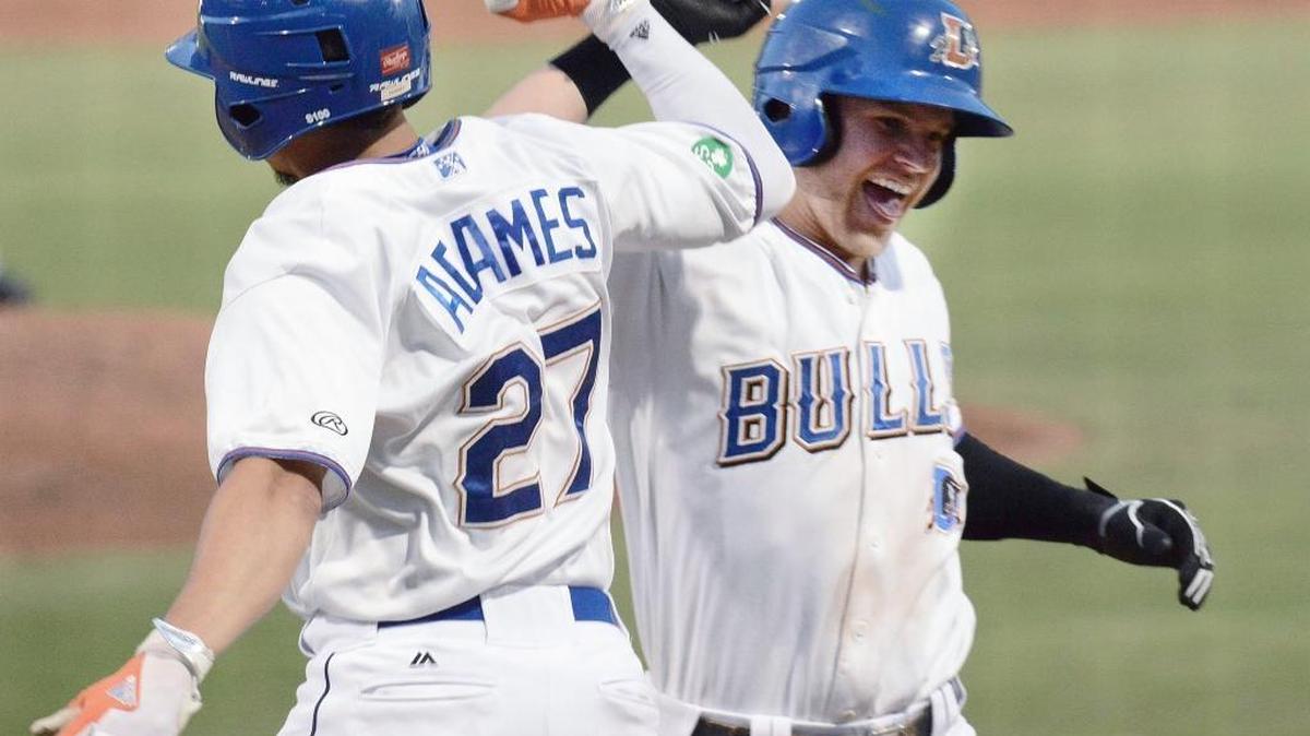 Durham Bulls' Jake Bauers (right), shown here celebrating with Willy Adames (27) during a June 2017 game at Durham Bulls Athletic Park, was named most valuable player of the International League finals Friday night as the Bulls won the league championship.