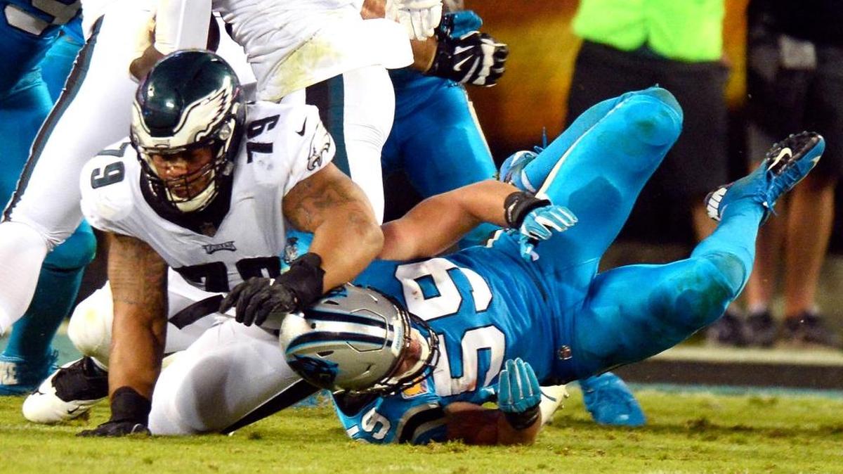 Carolina Panthers middle linebacker Luke Kuechly (59) is injured while going against Philadelphia Eagles offensive guard Brandon Brooks (79) in the first half at Bank of America Stadium on October 12, 2017.