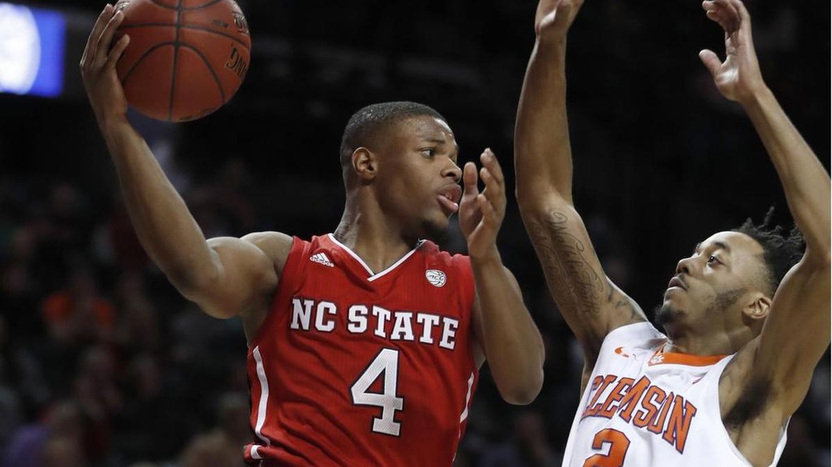 N.C. State's Dennis Smith Jr. (4) passes around Clemson's Marcquise Reed (2) during the second half of Clemson's 75-61 victory over N.C. State in the 2017 New York Life ACC Tournament at the Barclays Center in Brooklyn, N.Y., Tuesday, March 7, 2017.