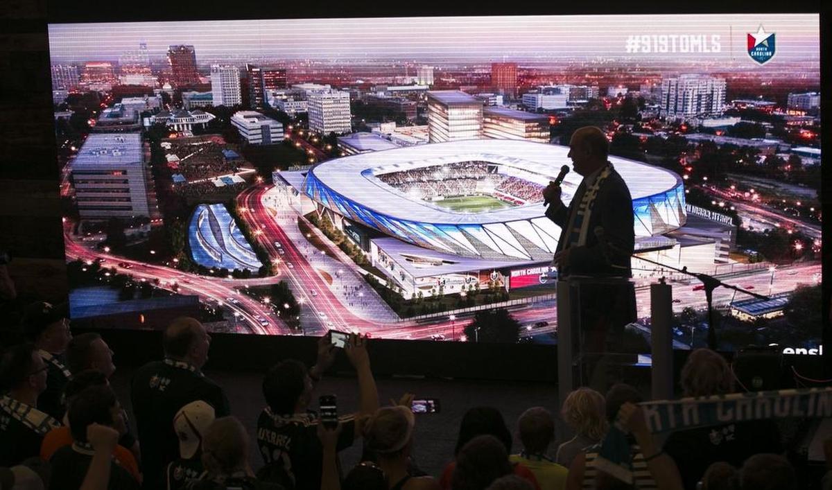 North Carolina Football Club president Steve Malik unveils a rendering of a proposed $150 million stadium and entertainment complex during a rally of soccer fans at City Market to promote Raleigh as a MLS expansion city on July 19, 2017.