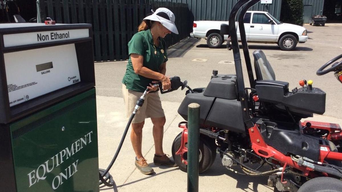 Kaye Pierson fills a mower with gas earlier this month. Pierson completed a golf Grand Slam after mowing the grass at the PGA Chamionship on Monday.