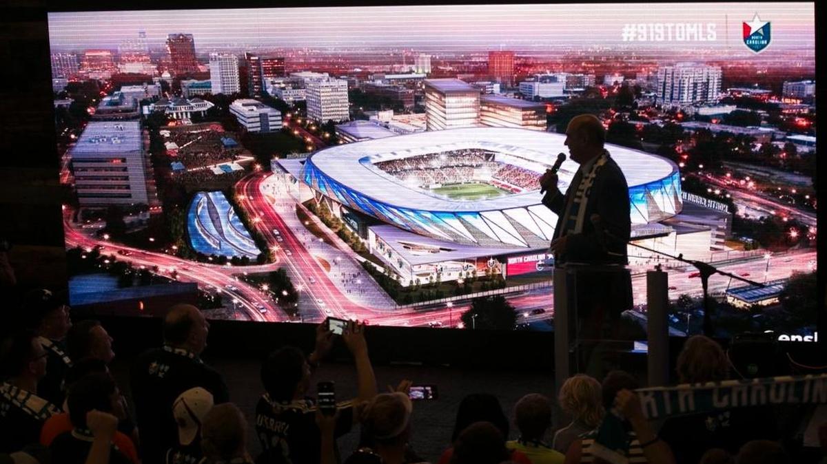 The North Carolina Football Club president Steve Malik unveils a rendering of a proposed $150 million stadium and entertainment complex during a rally of soccer fans at City Market to promote Raleigh as a MLS expansion city on July 19, 2017 in Raleigh.