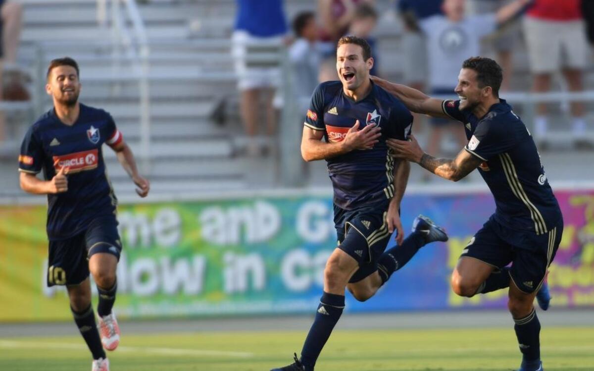 Steven Miller, center, of North Carolina F.C. celebrates along his teammates, Nazmi Albadawi, left, and Paul Black, right, after scoring the first goal. North Carolina F.C. played Houston Dynamo in a soccer game that counted for the Lamar Hunt U.S. Open Cup that took place at the WakeMed Soccer Park in Cary, N.C. on Wednesday, June 14, 2017. Houston Dynamo won 3-2 in overtime.