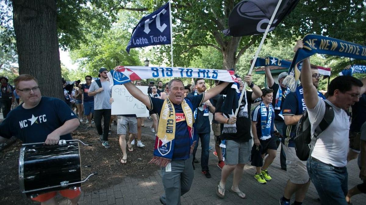 Triangle soccer fans march through Moore Square to a rally at City Market to promote Raleigh as an MLS expansion city on Wednesday.