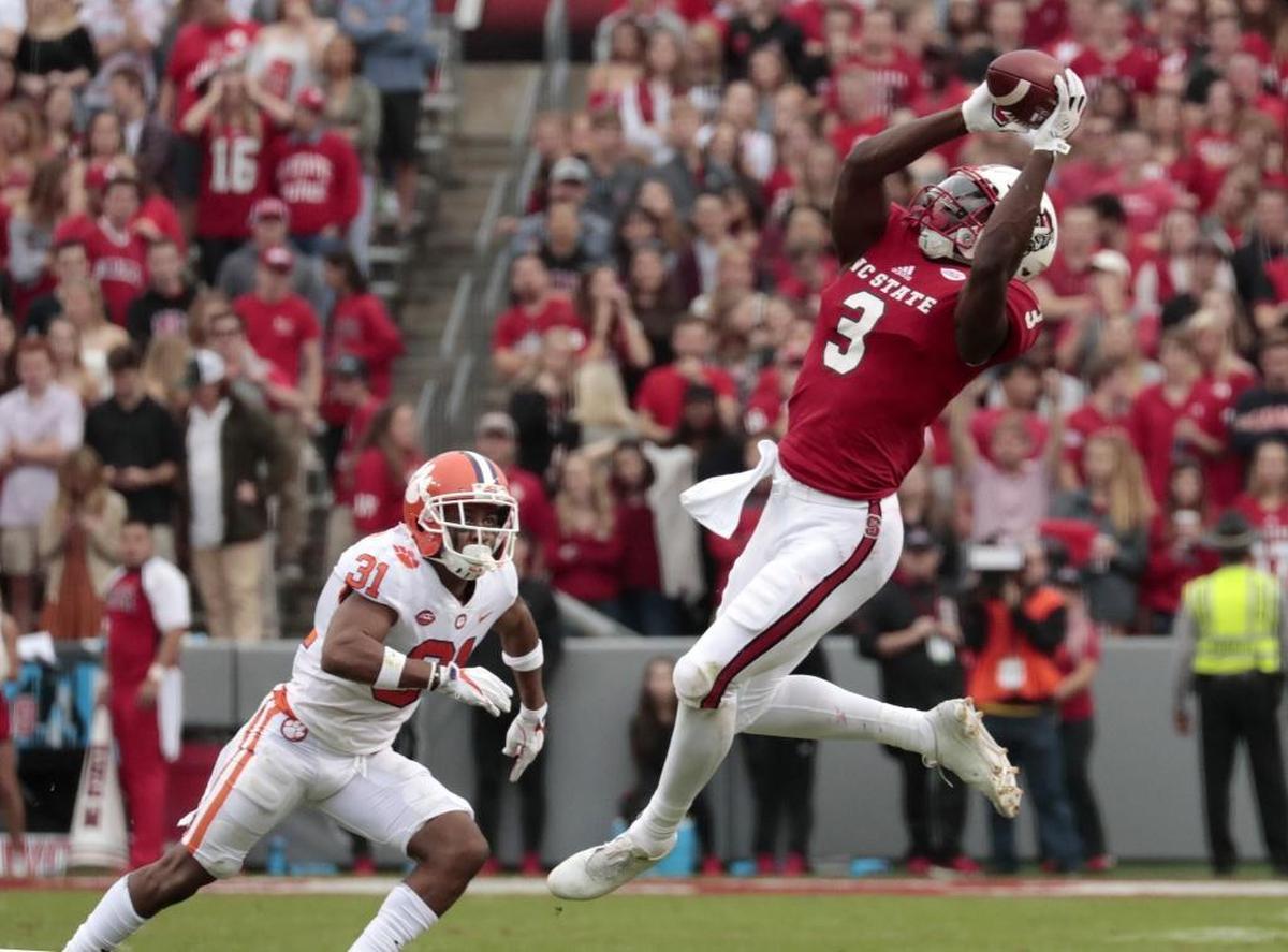 N.C. State's Kelvin Harmon (3) hauls in a pass over Clemson's Ryan Carter (31) during the second quarter of an ACC college football game between the N.C. State Wolfpack and the Clemson Tigers played at Carter-Finley Stadium in Raleigh, NC on Nov. 4, 2017. Clemson beat N.C. State 38-31.