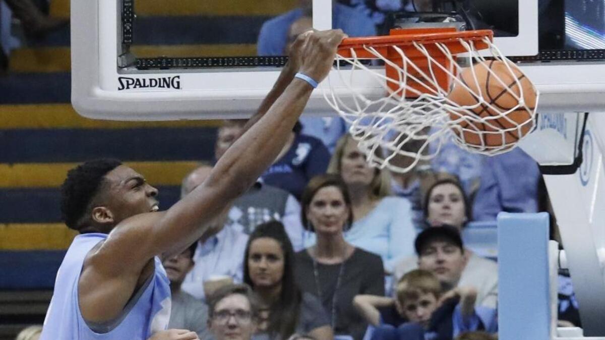 Brandon Huffman (42) slam dunks the ball during a scrimmage as the UNC Tar Heel basketball team has its annual “Late Night with Roy” event to open the college basketball season at the Dean Smith Center in Chapel Hill, on Oct. 13.