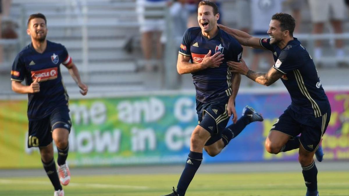 Steven Miller, center, of North Carolina F.C. celebrates with Nazmi Albadawi, left, and Paul Black, right, after scoring goal against the Houston Dynamo at the WakeMed Soccer Park in Cary on June 14, 2017. Dynamo won 3-2 in overtime.