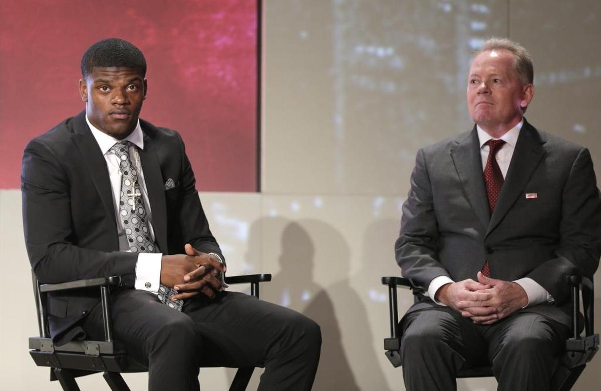 Louisville head coach Bobby Petrino, right, and Lamar Jackson, left, listen to an interview during the Atlantic Coast Conference NCAA college football media day in Charlotte on July 13, 2017. (AP Photo/Chuck Burton)