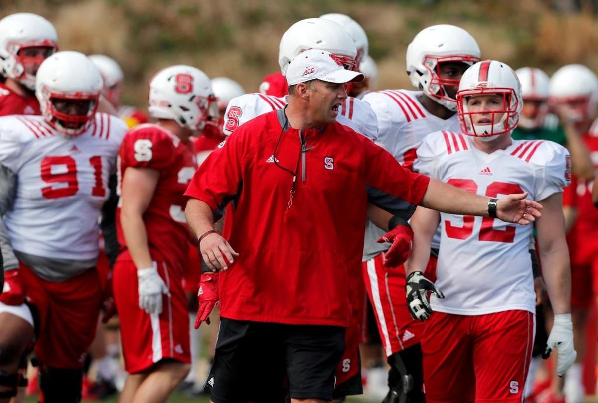 N.C. State head coach Dave Doeren yells to his players during N.C. State football's third spring practice at the Curtis and Jacqueline Dail football practice complex in Raleigh on Feb. 28, 2017.