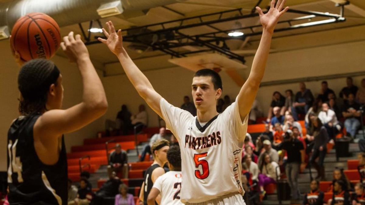 With Red Wolves #14 Kahlil Barnett stuck in the corner, Panther #5 Connor Crabtree defends with outstretched hands. The Cedar Ridge Red Wolves and Orange Panthers basketball game in Hillsborough, N.C. on Wednesday, February 17, 2016. Orange won 76-62.