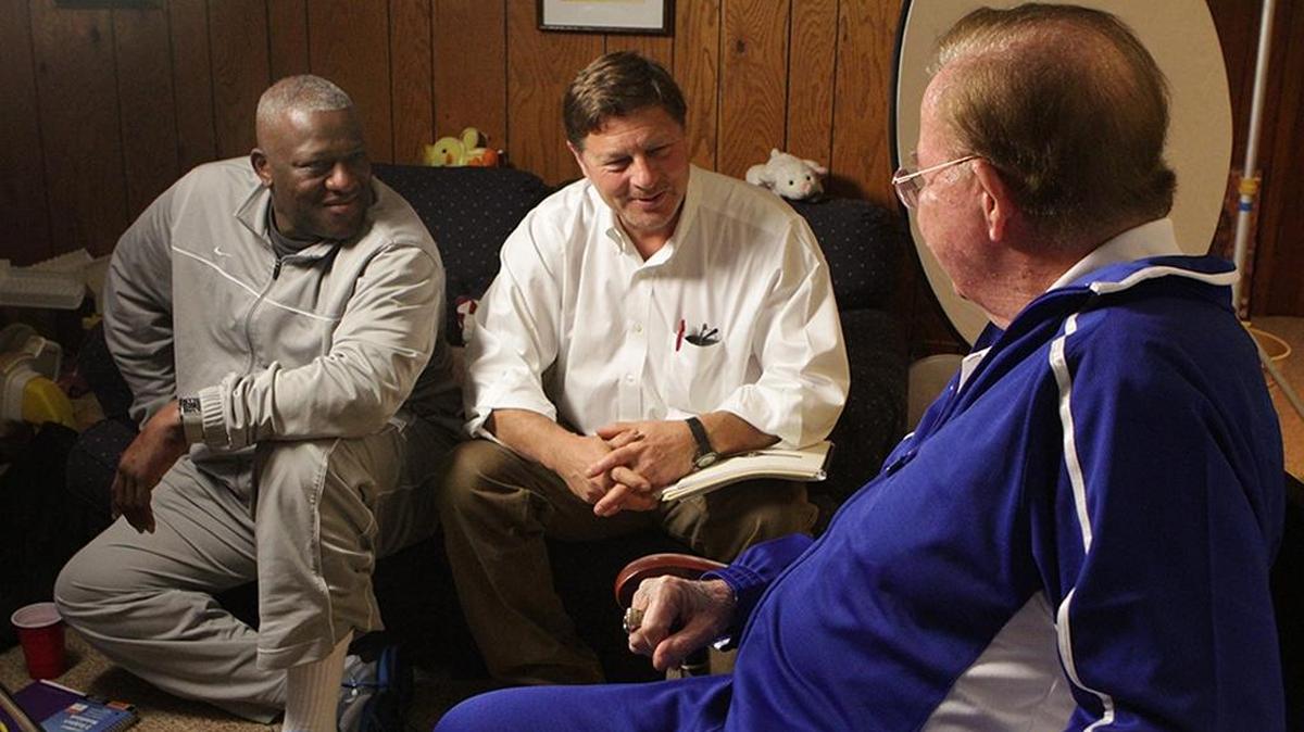 Former N.C. State guard Dereck Whittenburg and Carrboro filmmaker Bill Hayes speak with Morgan Wootten while working on a film about the Hall of Fame high school basketball coach’s career.